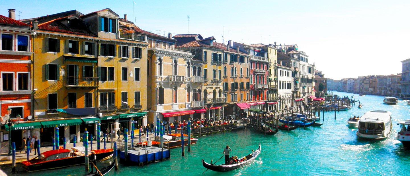 在意大利，河的两边都有五颜六色的建筑，里面有船