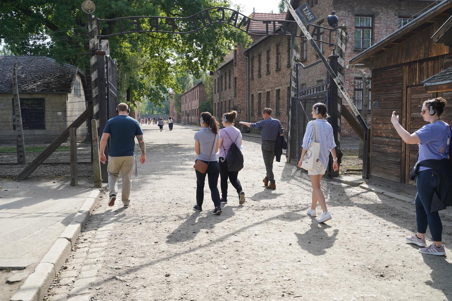 A group of OUWB students and faculty walk through the entrance gate to Auschwitz 1